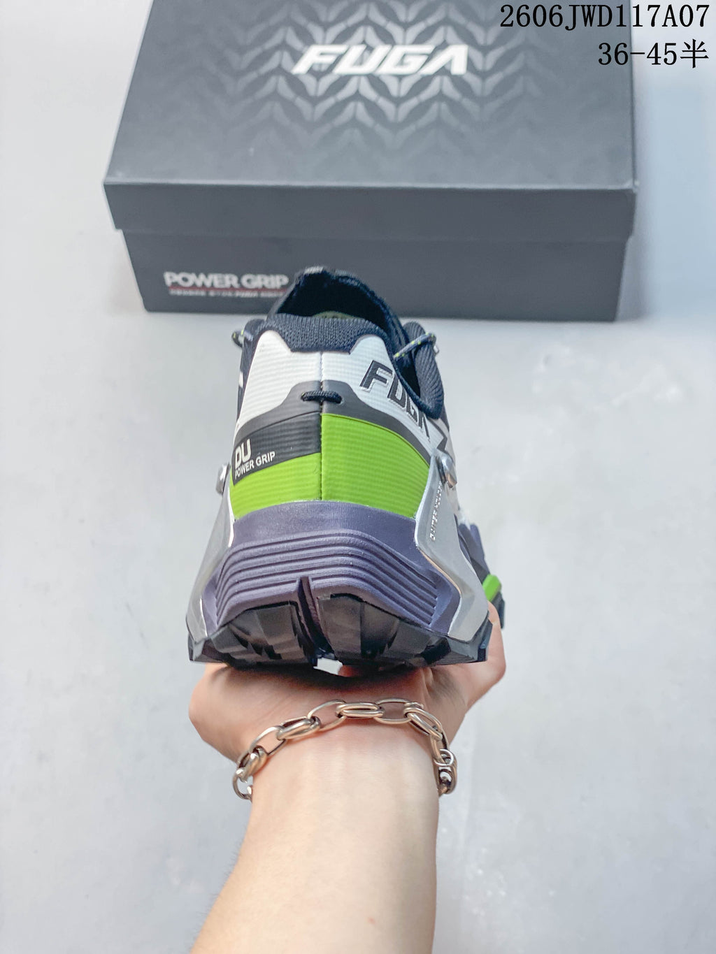 Rear view of the shoe showing its heel design and green accent panel.