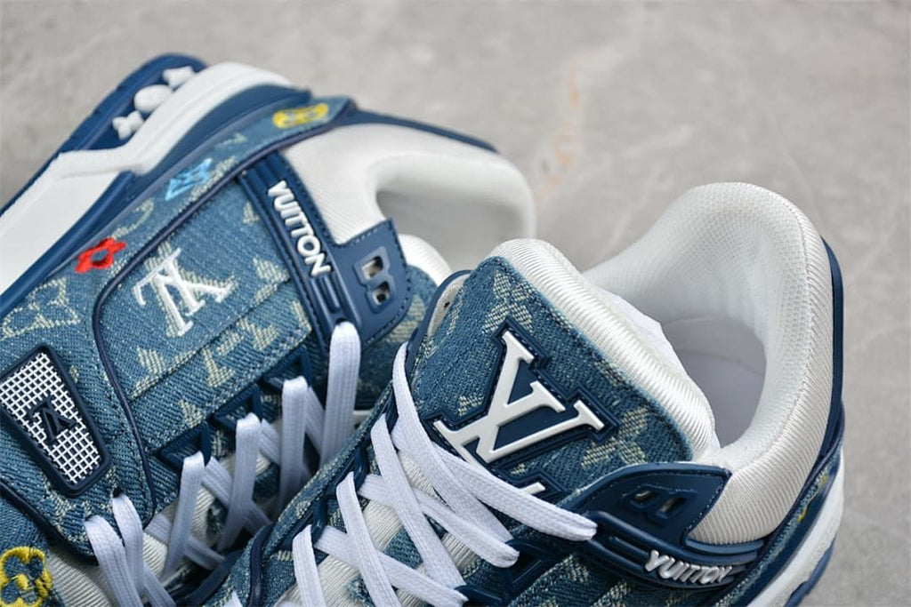 Close-up of the blue patterned sneakers, white laces, tongue logo and padded collar.