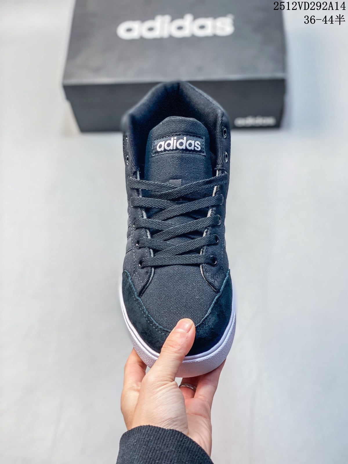 Front view of a dark lace-up Adidas high-top sneaker with a white sole.