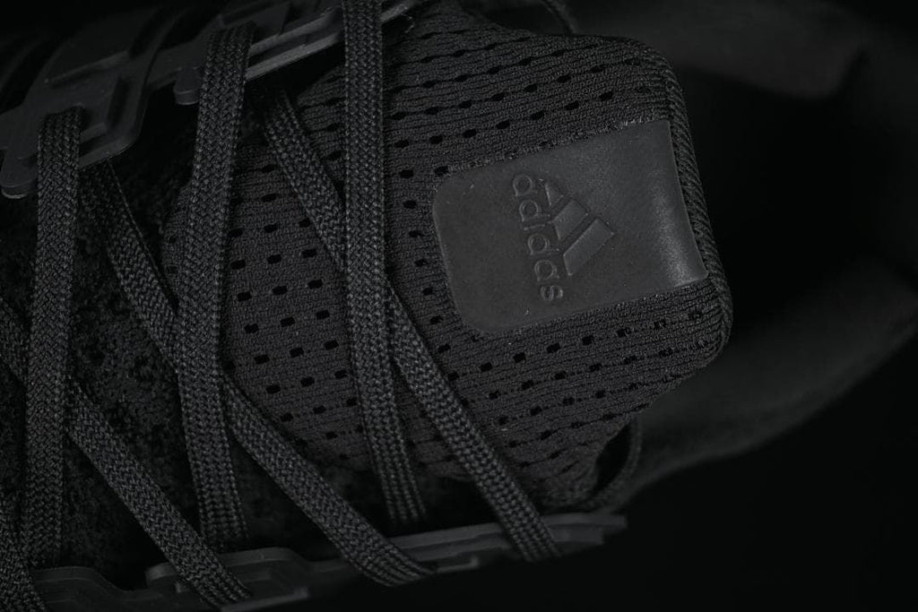 Close-up of the tongue with adidas branding and black laces.