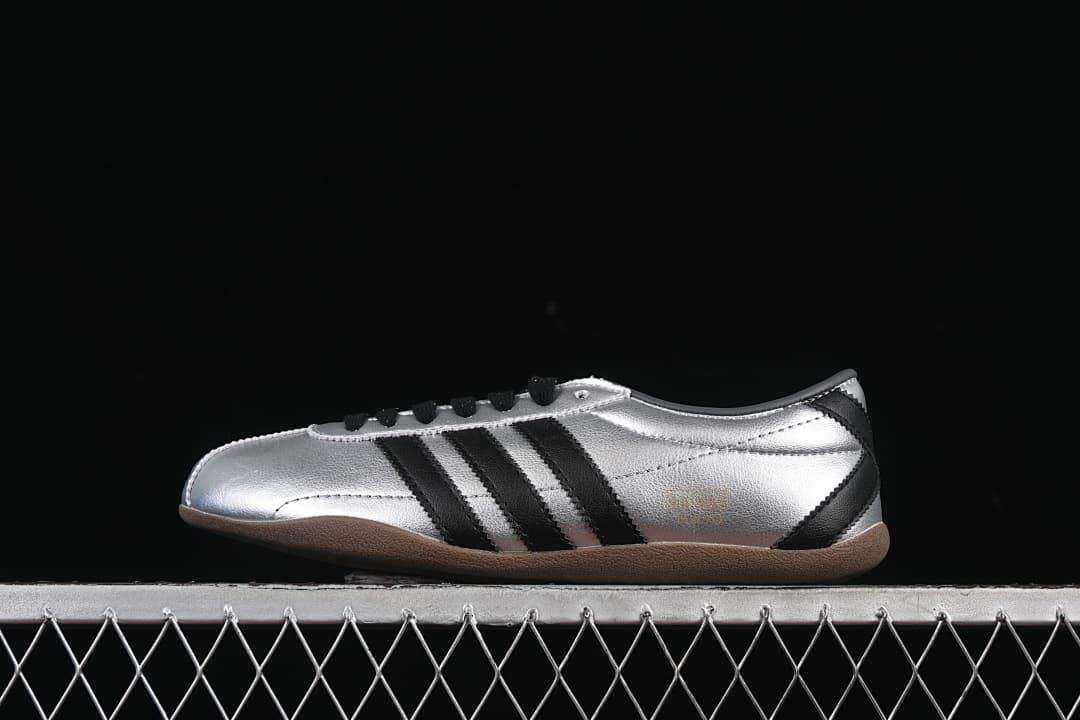 Side profile of silver adidas Tokyo Decon W sneakers with black stripes and gum-colored outsole
