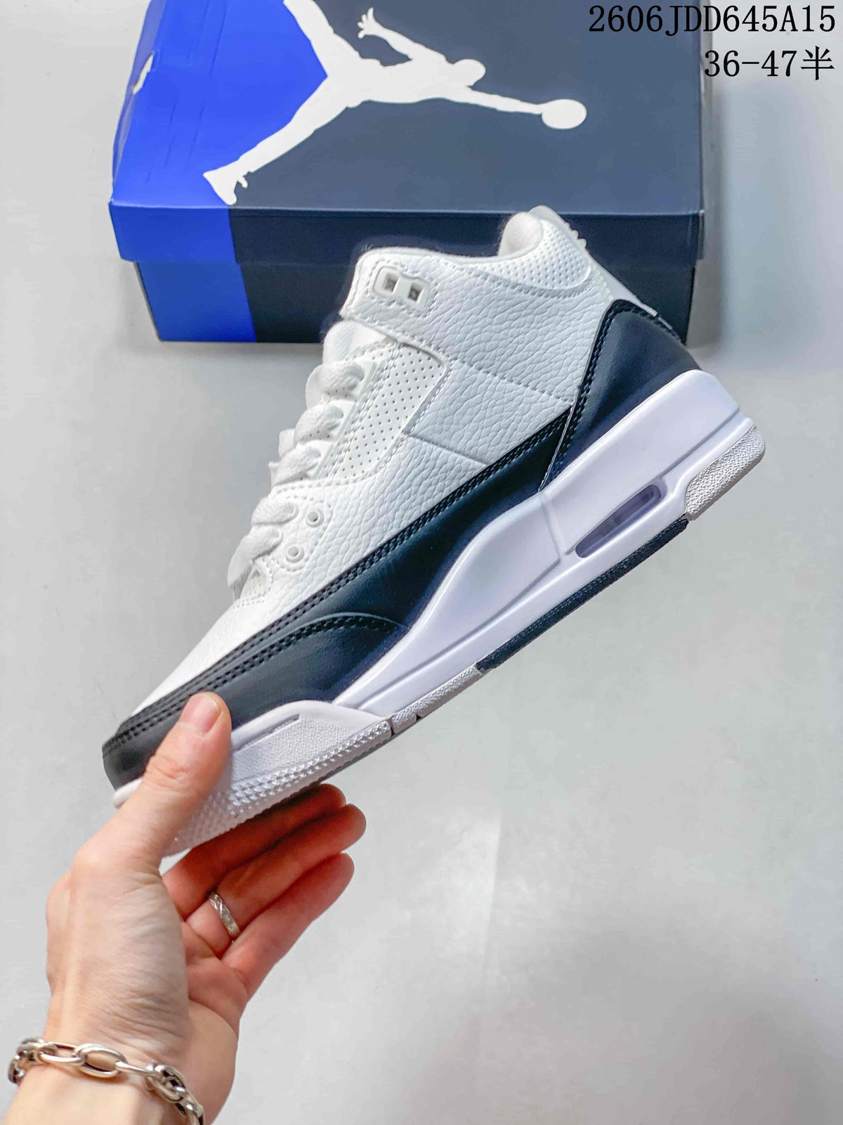 Side view of a white Air Jordan 3 Retro with dark overlays