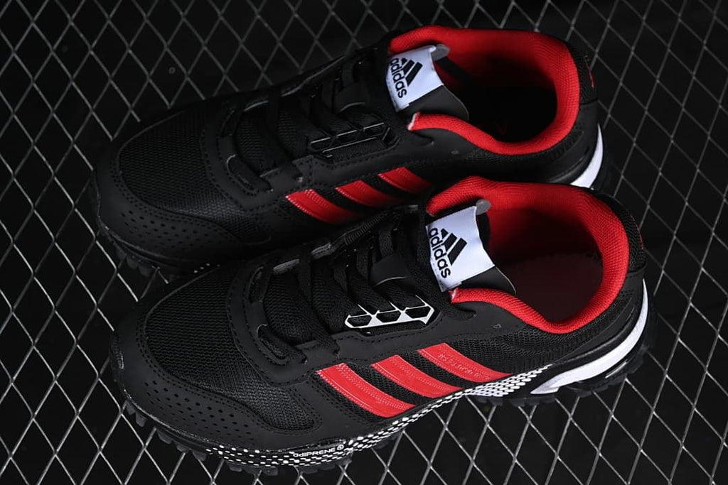 Pair of black and red sneakers shown from above.