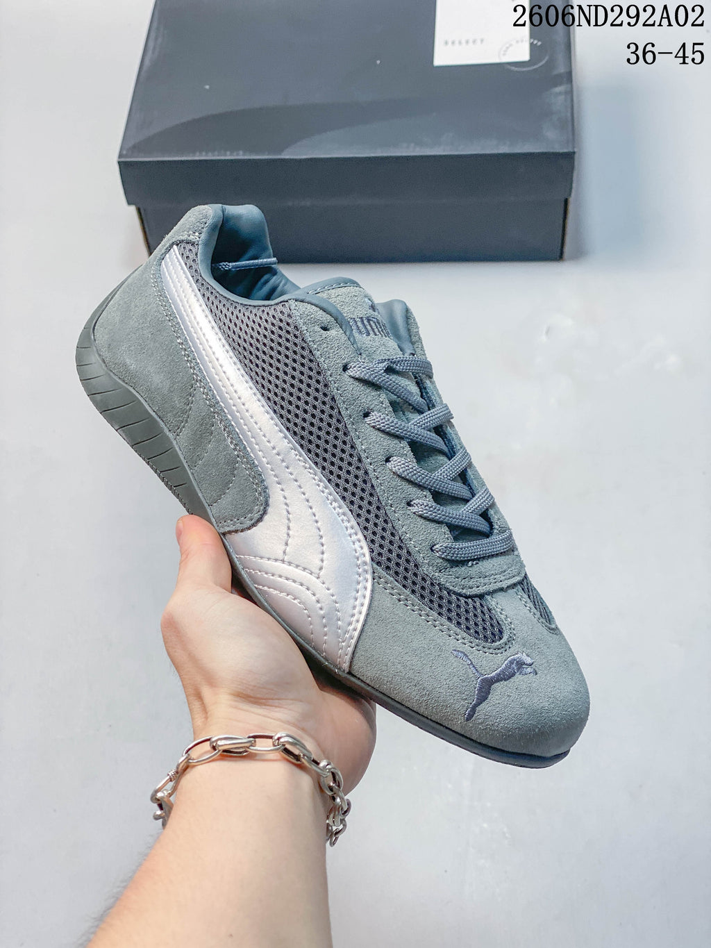 Gray Puma Speedcat The Open YY sneaker with a dark mesh-look panel and pale side stripe