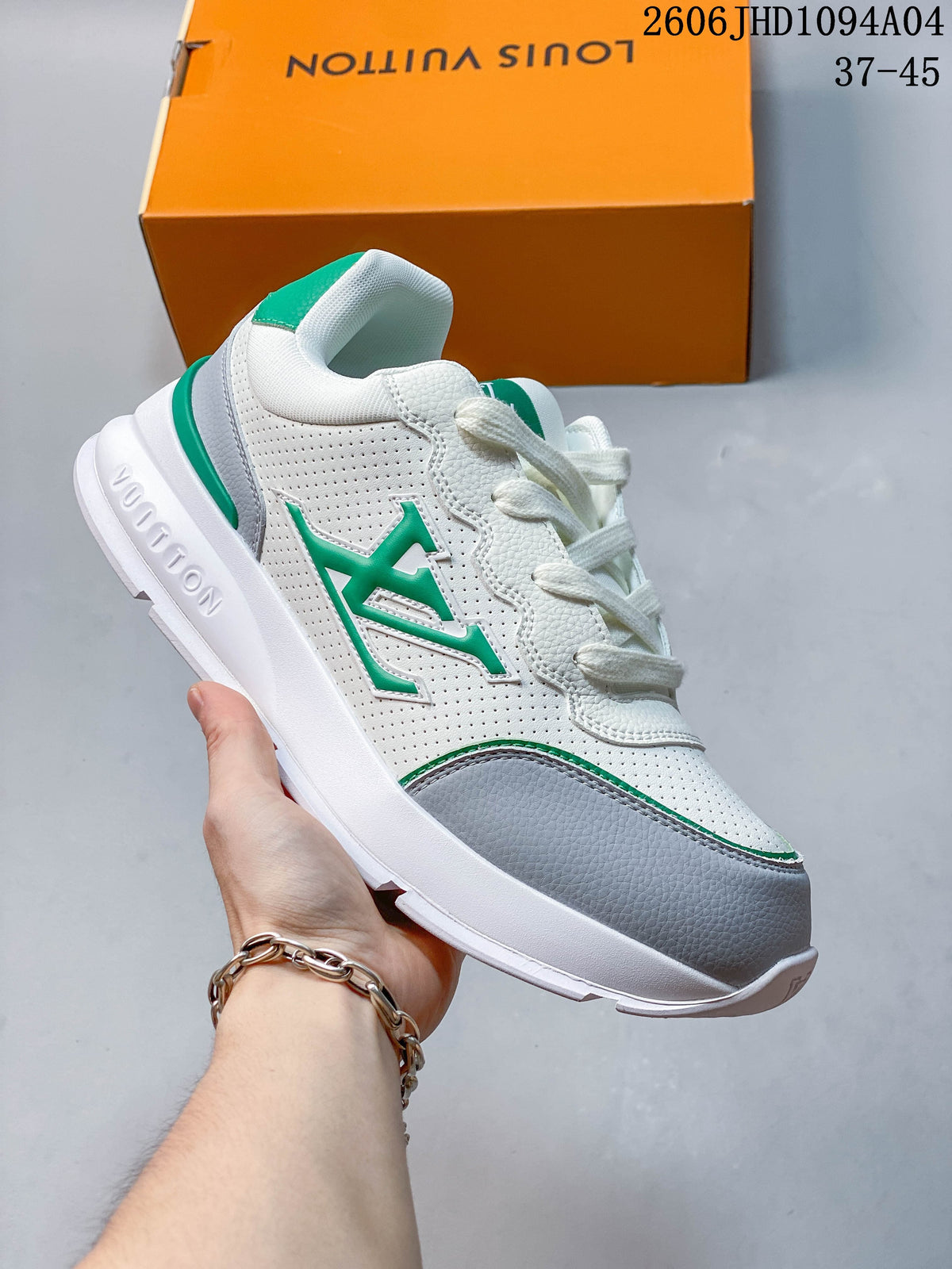 White low-top Louis Vuitton Trainer sneaker with green accents and a gray toe panel