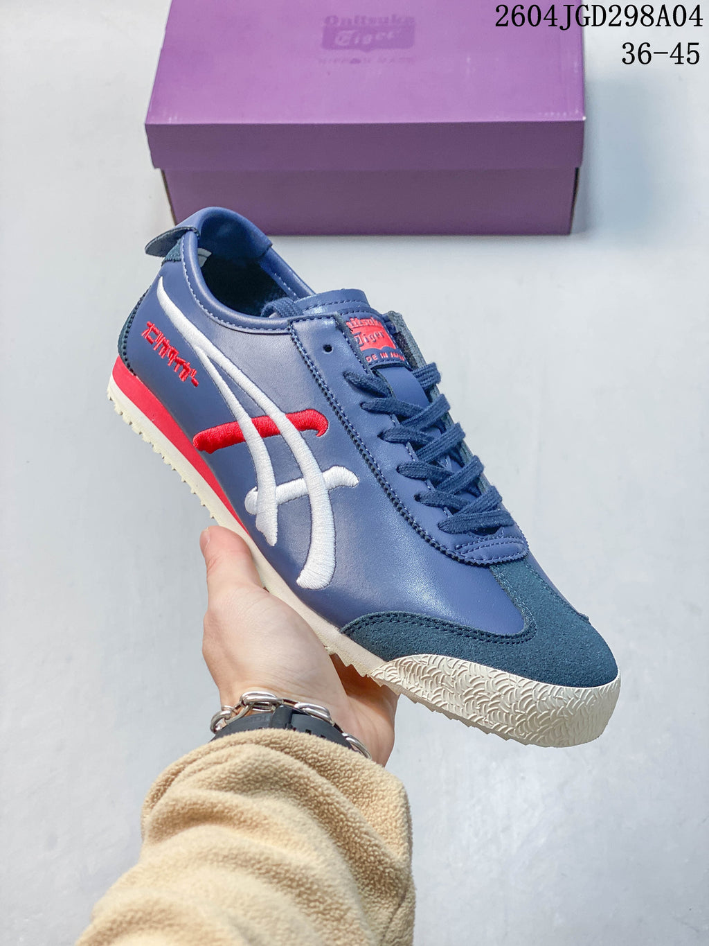 Blue Onitsuka Tiger Mexico 66 Deluxe sneaker with red and white side stripes.
