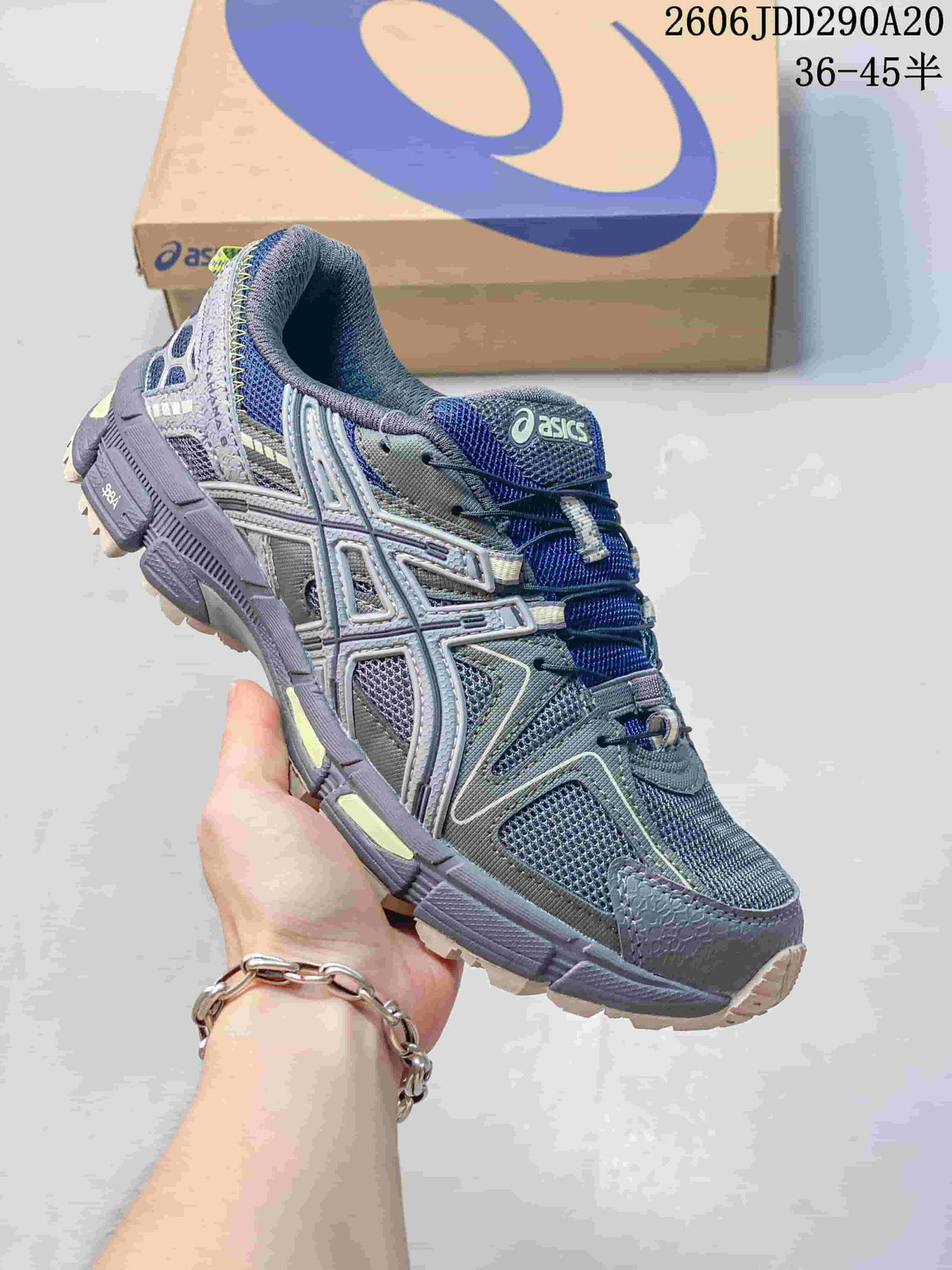 Close-up of a gray and navy ASICS Gel-Kahana 8 sneaker, showing its side detailing and lugged outsole.