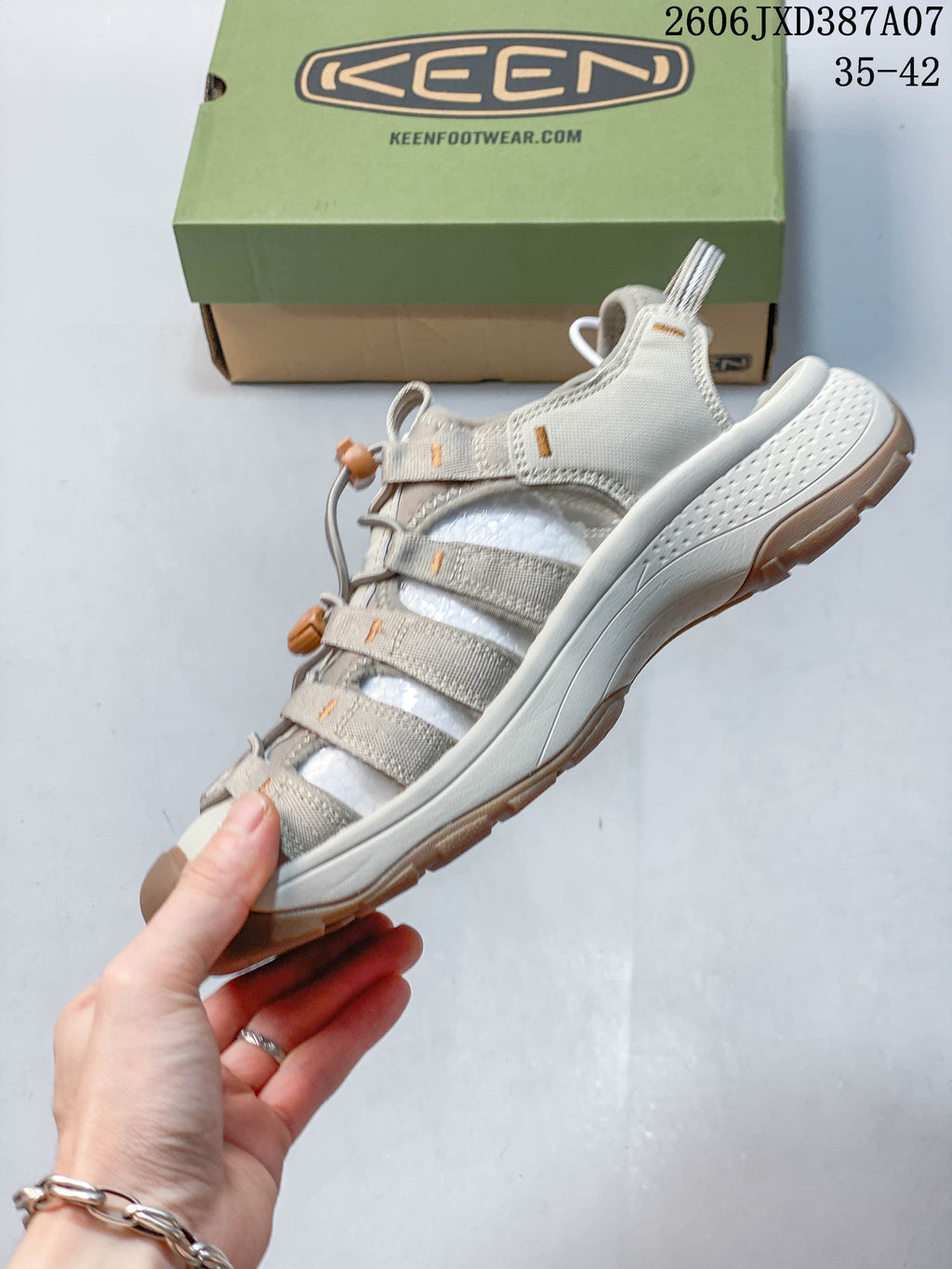 Side view of the light beige closed-toe sandal with cord lacing and toggle; image overlay shows 35–42.