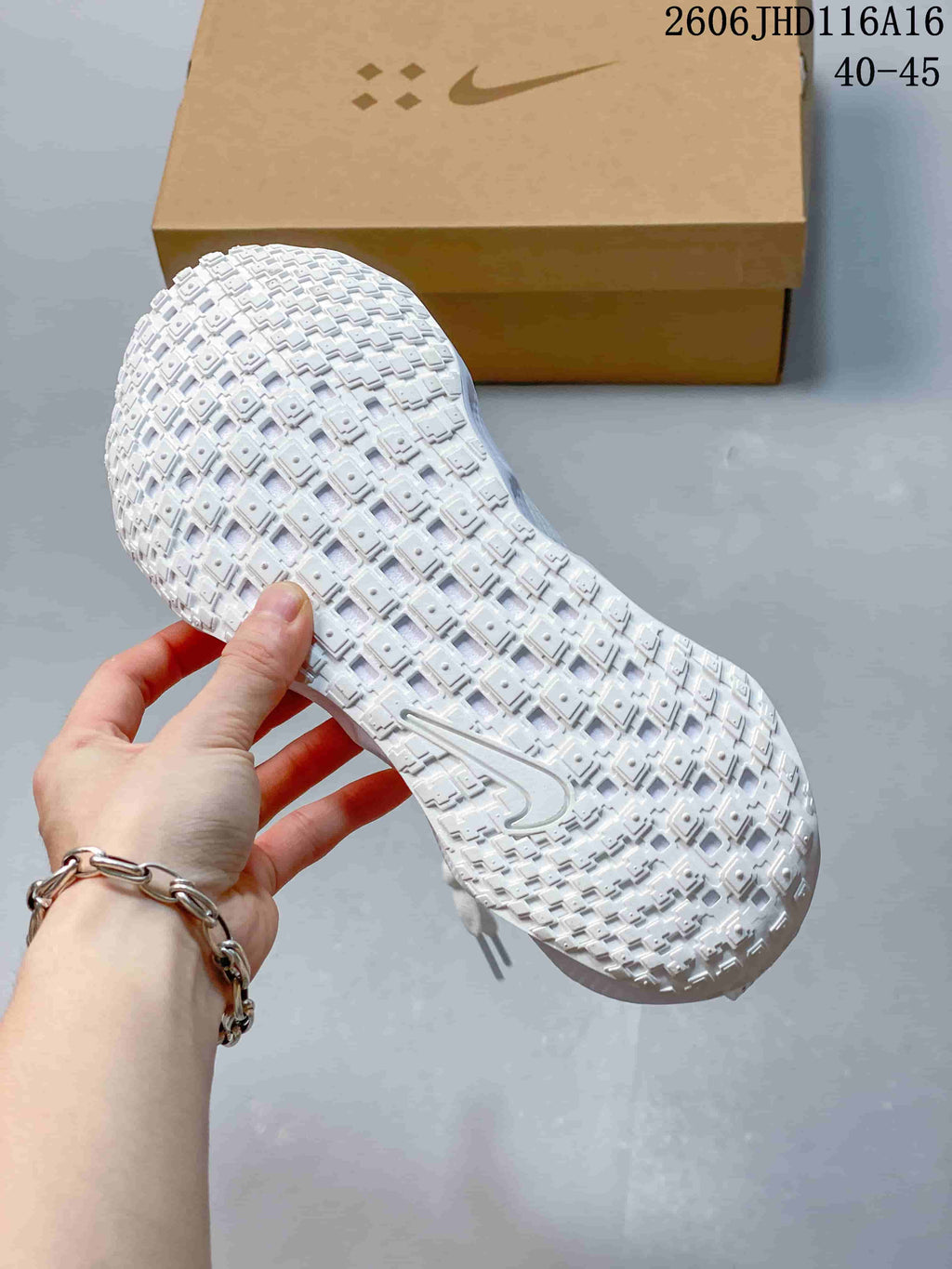 Close-up of the textured outsole on a white Nike Ava Rover shoe.
