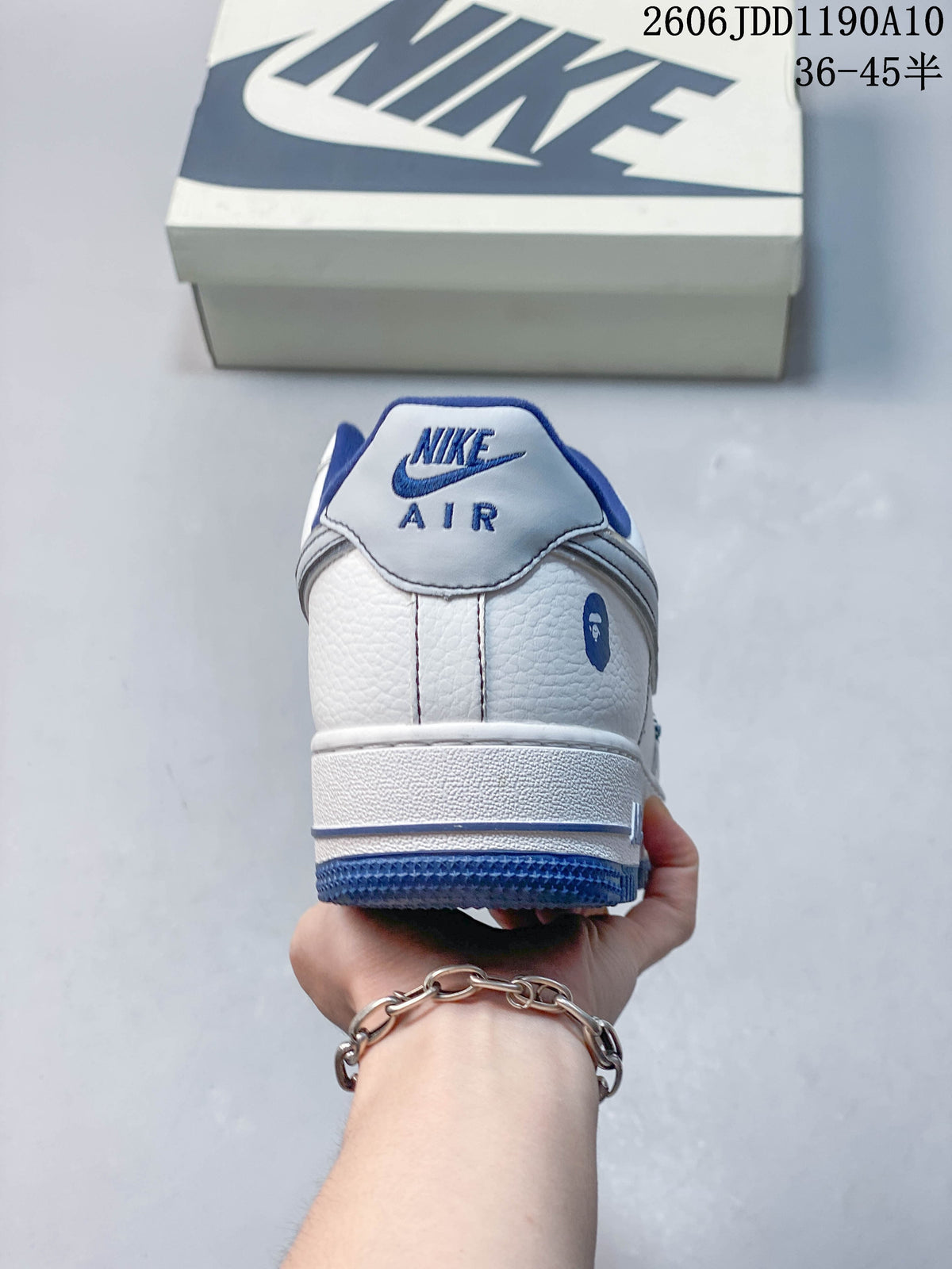 Rear view of a white sneaker with blue accents