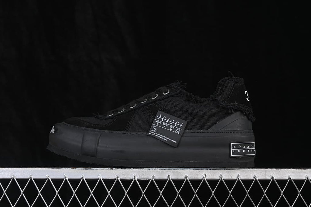 Black xVESSEL low-top sneaker with a chunky sole, shown in side profile