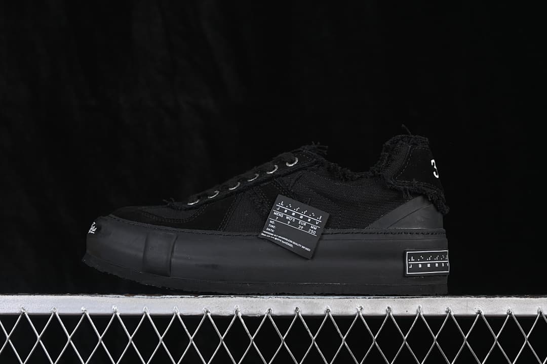 Black xVESSEL low-top sneaker with a chunky sole, shown in side profile