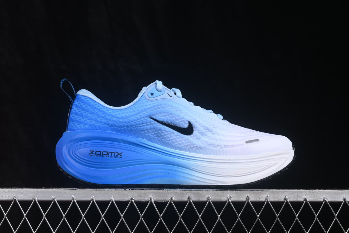 Side profile of the shoe showing the white-to-blue color transition and visible ZoomX marking on the midsole.
