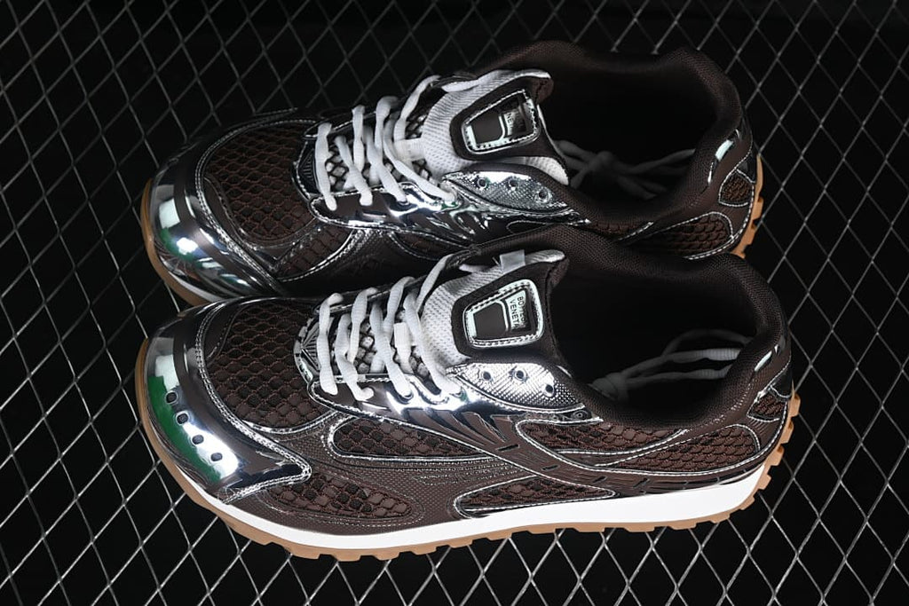 Pair of brown and silver-tone Orbit sneakers with white laces.