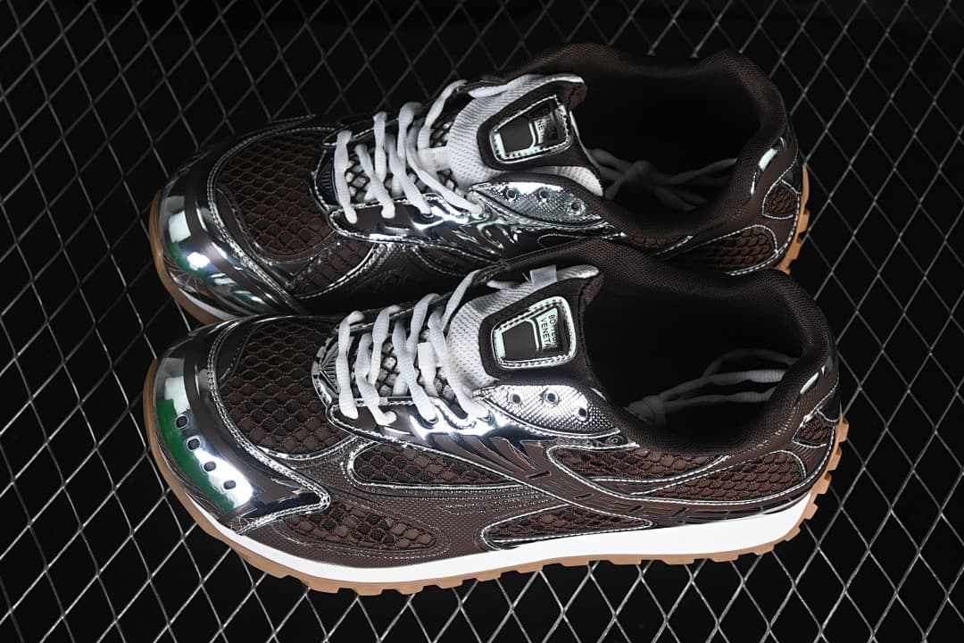 Pair of brown and silver-tone Orbit sneakers with white laces.