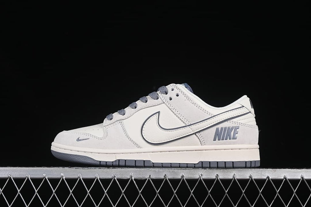 Side view of beige and gray Nike SB Dunk Low sneakers with gray laces and outsole