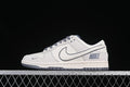 Side view of beige and gray Nike SB Dunk Low sneakers with gray laces and outsole