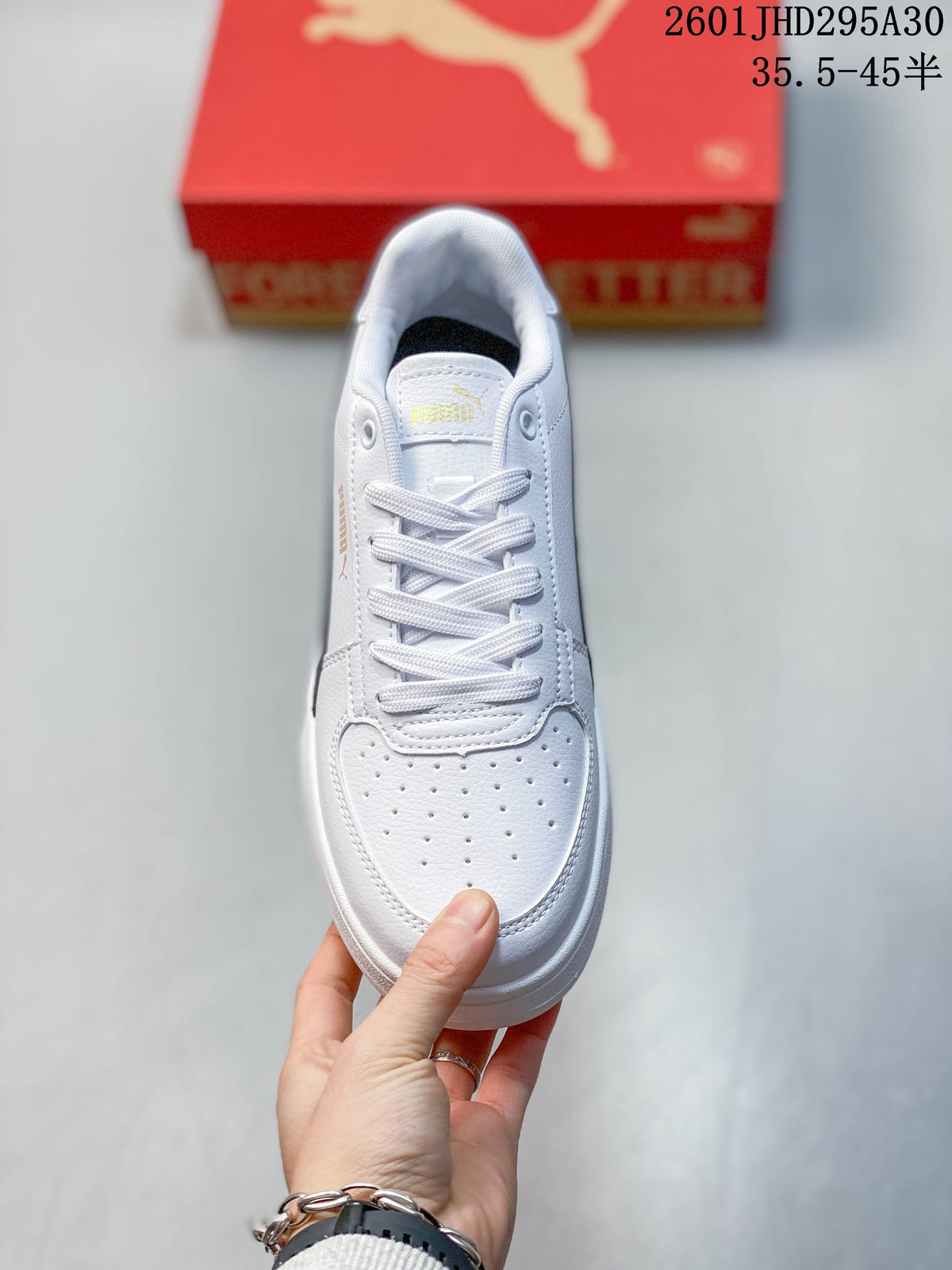 Top view of a white Puma Caven 2.0 sneaker with lace-up front and perforated toe
