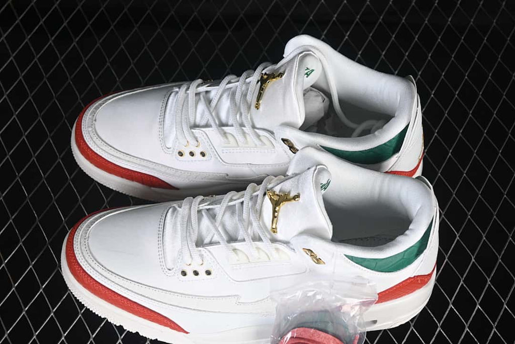 Pair of white, red, and green Jordan sneakers shown from above at an angle