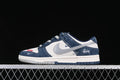 Side view of a navy, white, and gray low-top Dunk-style sneaker