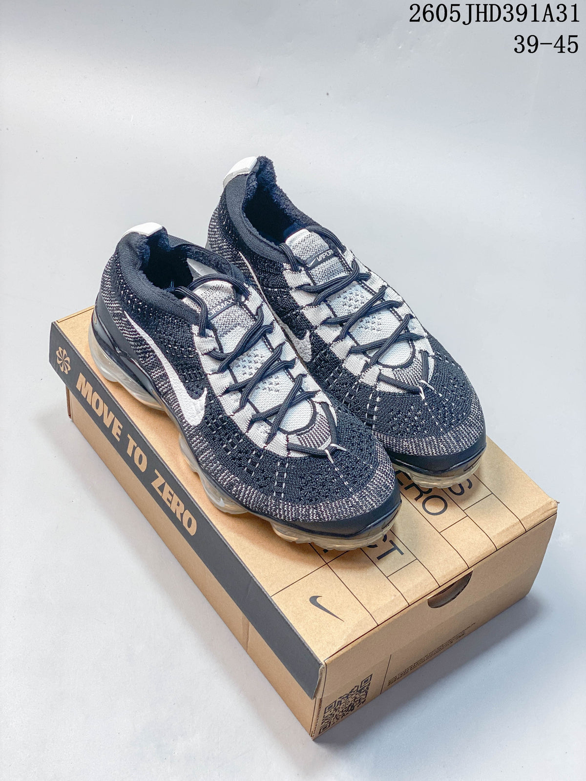 Pair of navy, gray, and white Nike Air VaporMax 2023 Flyknit-style running shoes on a Move to Zero box