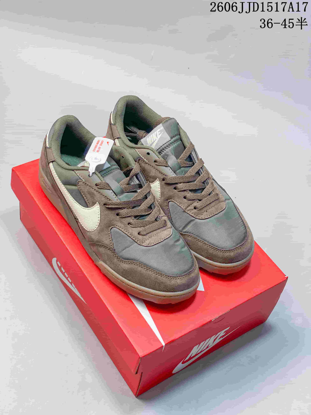 Pair of olive, brown, and cream Nike Terra Manta sneakers on a red Nike box