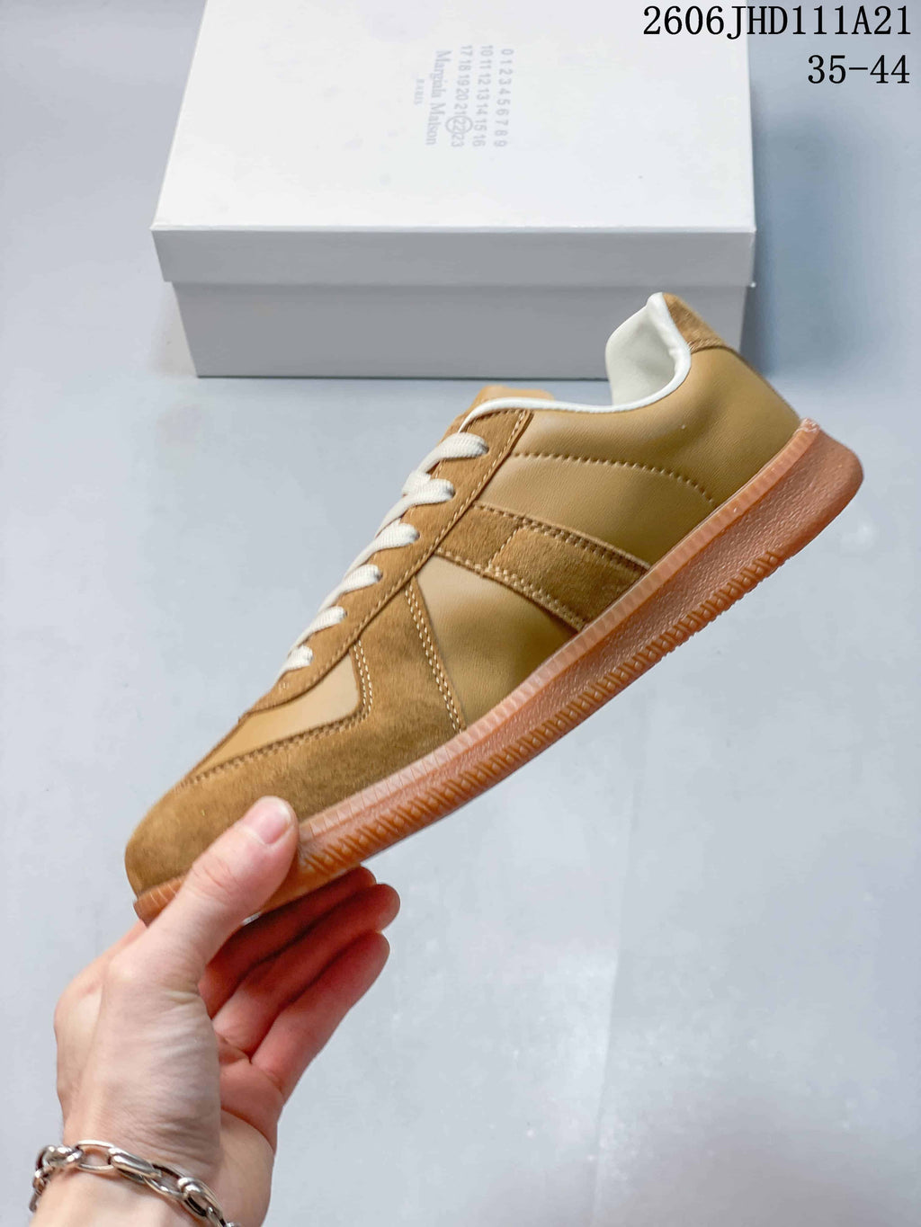 Side view of the tan sneaker with suede-textured overlays and gum sole