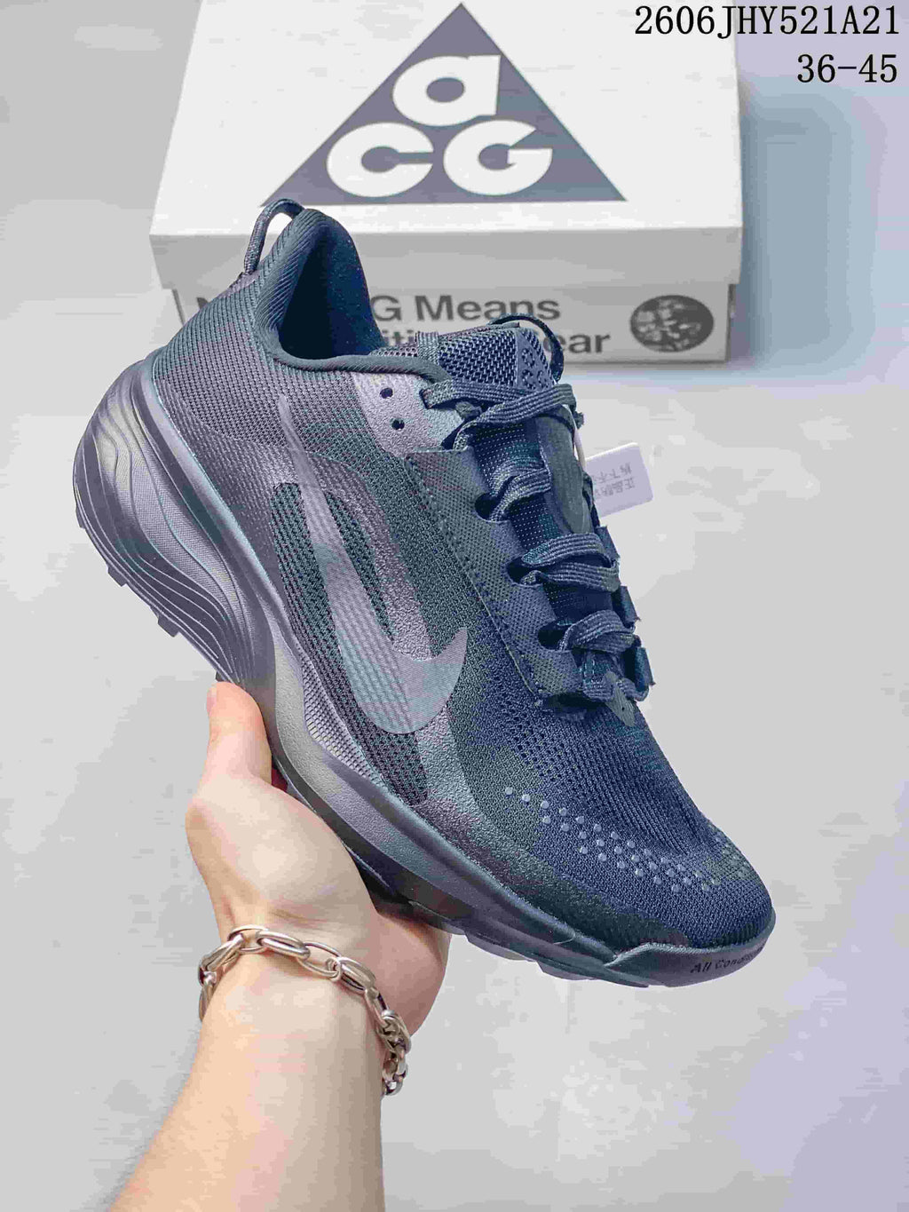 Angled side view highlighting the dark gray upper, Nike Swoosh, and outsole.