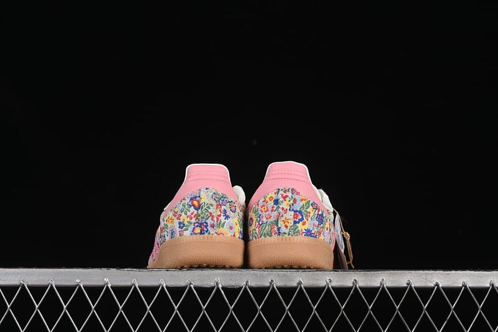 Rear view of the pair showing patterned heel panels and pink heel tabs.