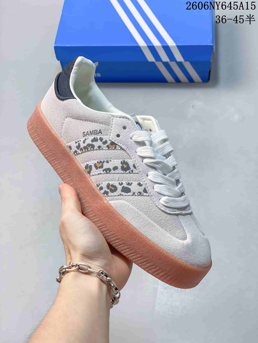 Close-up of an off-white Adidas Sambae sneaker with patterned side stripes and a raised gum-look sole.