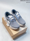 Pair of grey On Cloudmonster 3 shoes with light blue accents on a box.