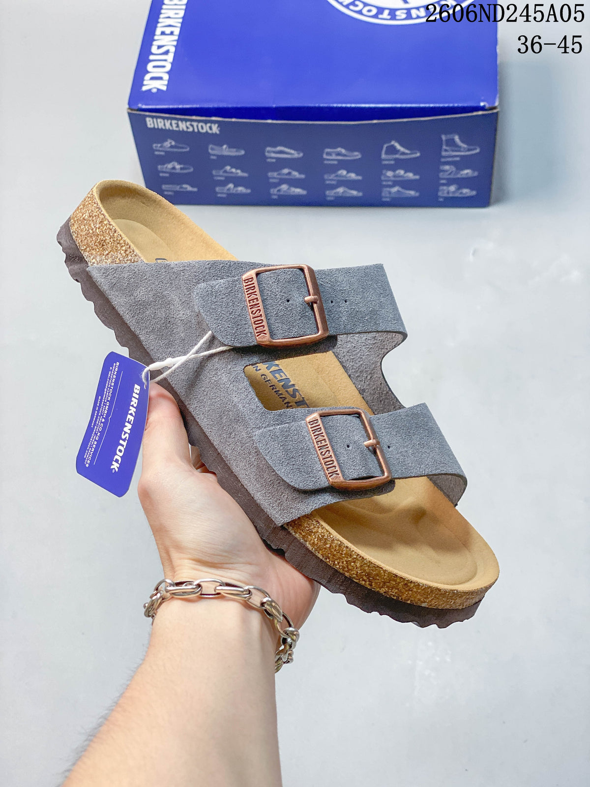Gray two-strap slide sandal shown at an angle with adjustable buckles.