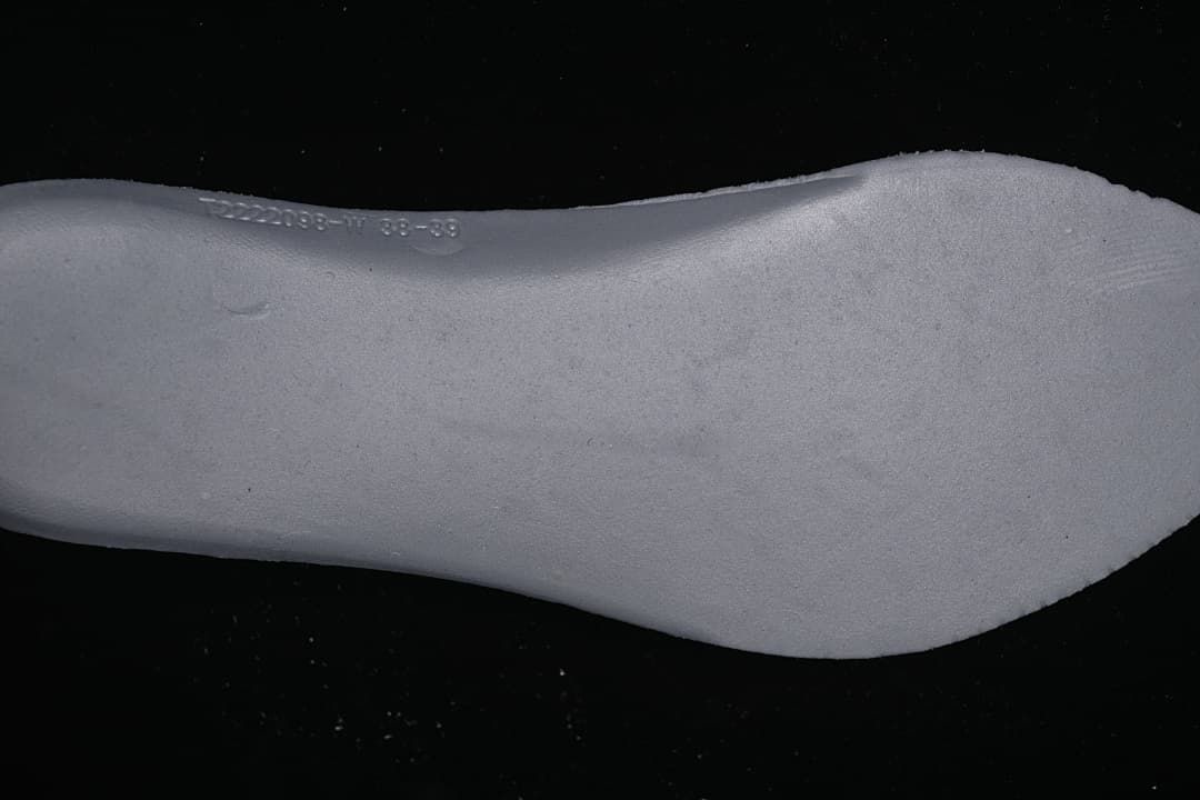 Close-up of the sneaker sole sidewall with a molded marking.
