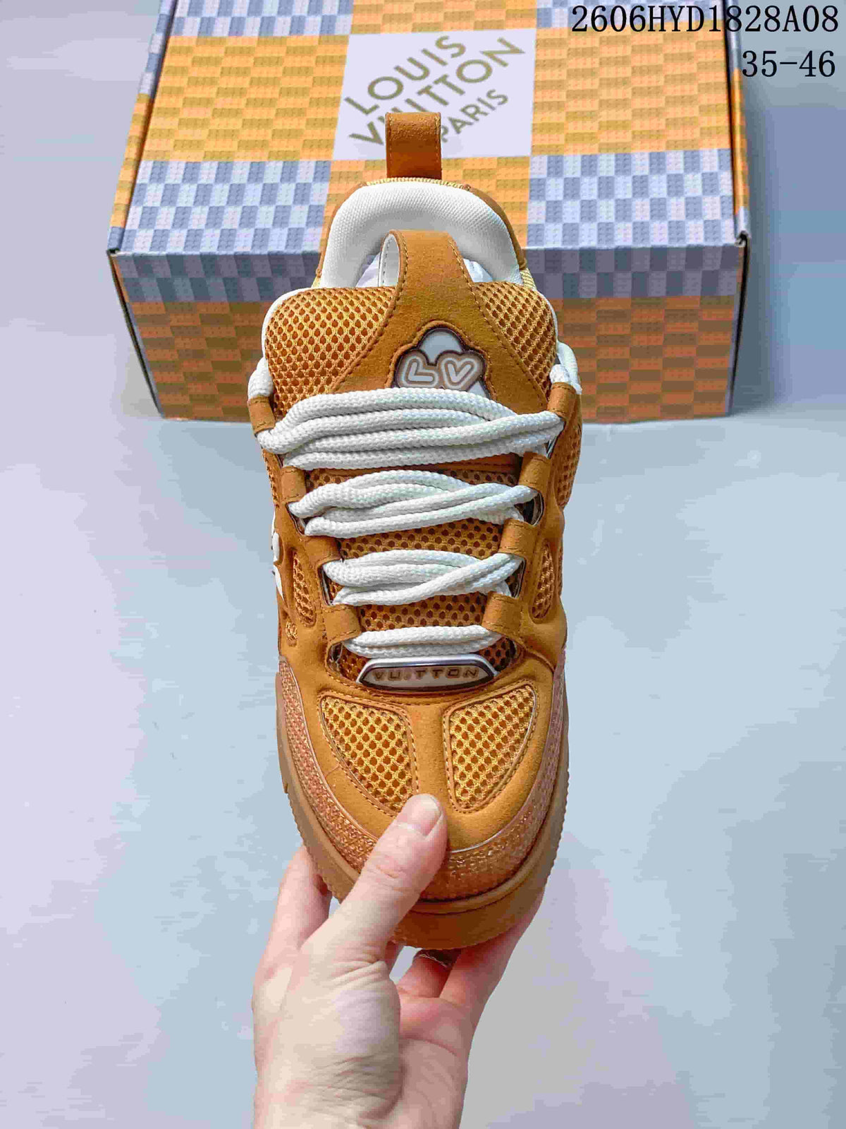 Front view of the brown sneaker showing mesh panels and white laces