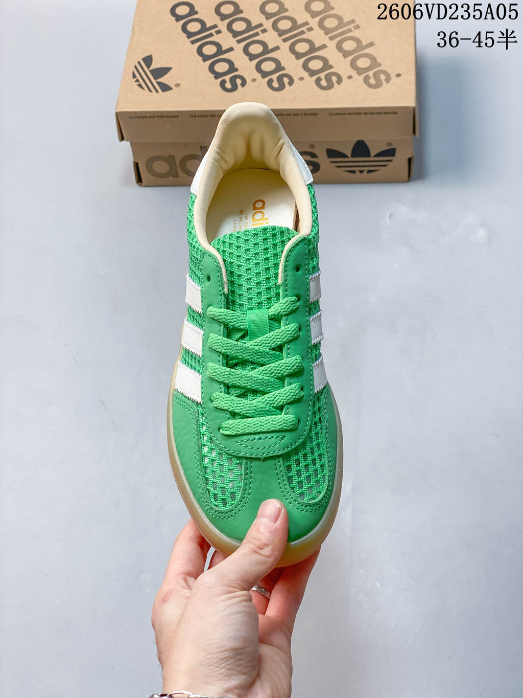 Top view of the green lace-up sneaker with white side stripes.