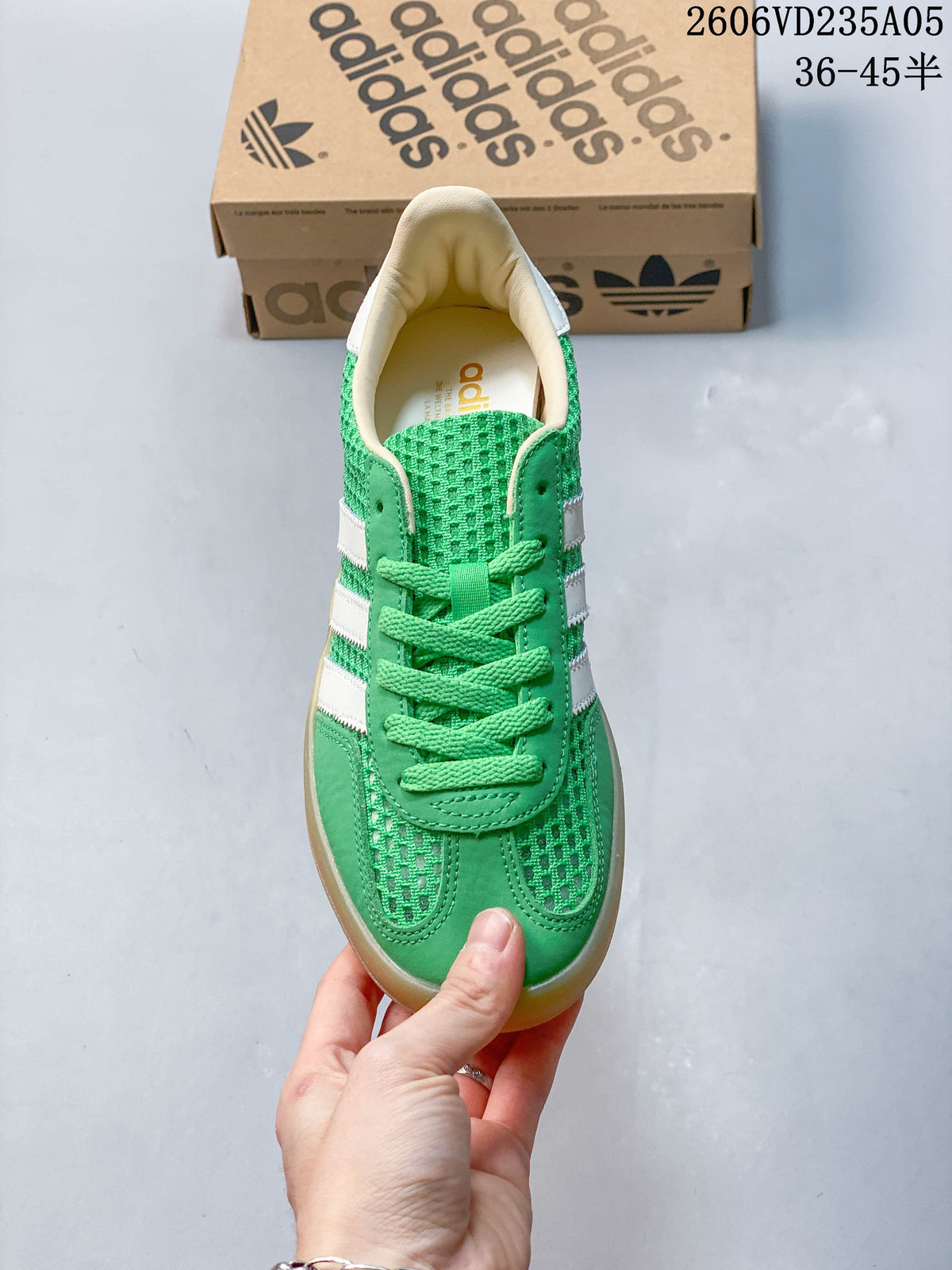 Top view of the green lace-up sneaker with white side stripes.