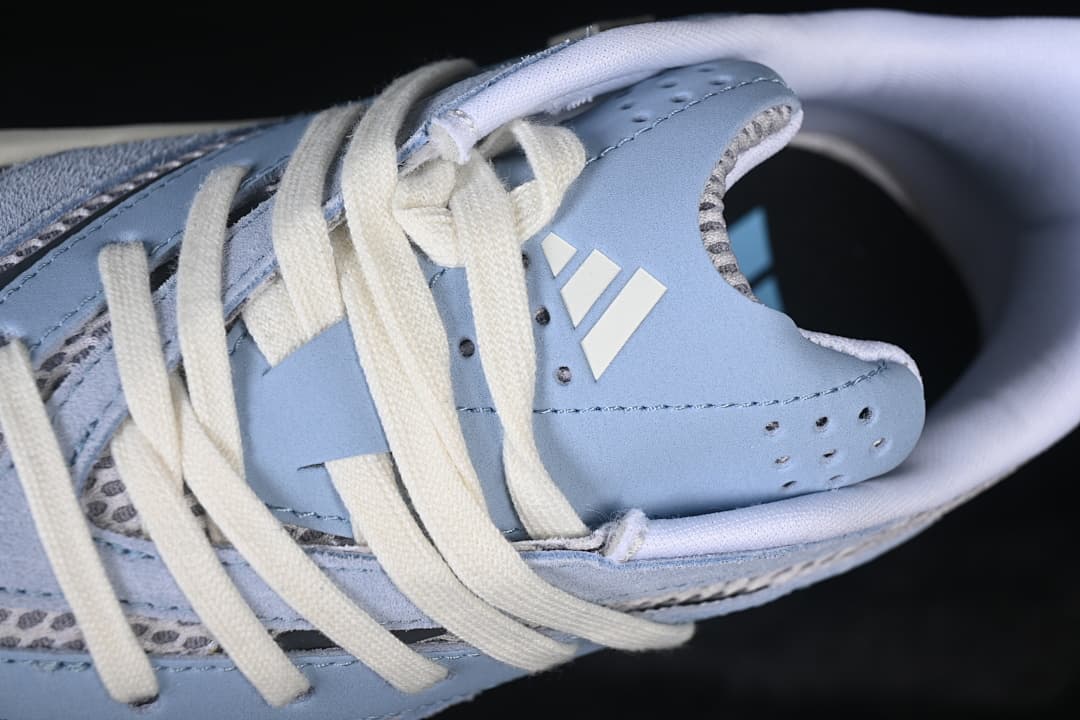 Close-up of the tongue logo and cream laces