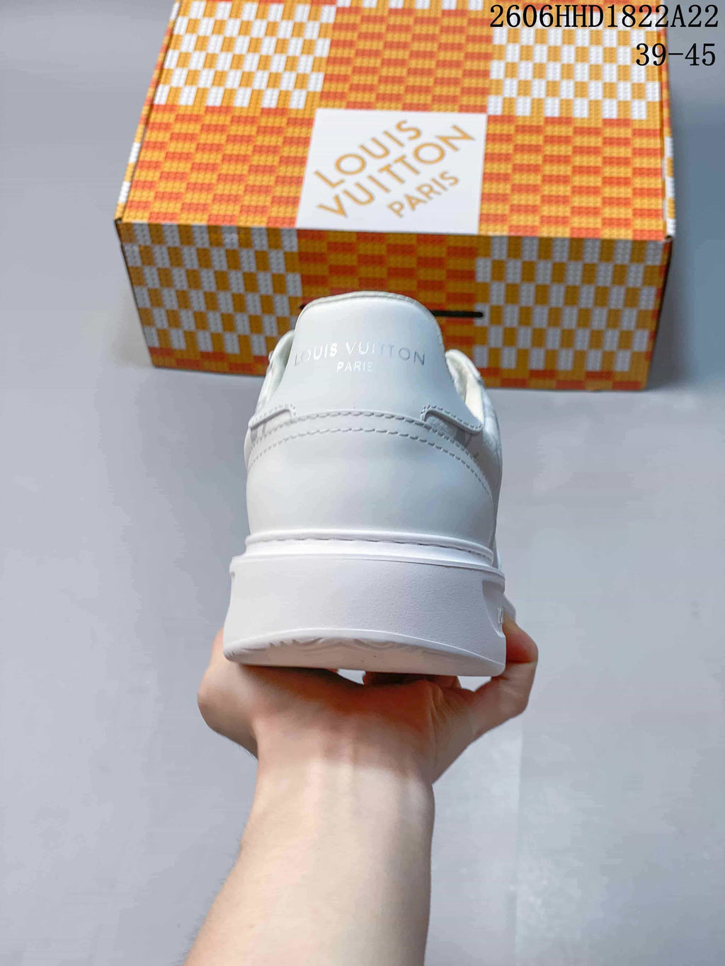 Rear view of a white low-top sneaker with a thick sole