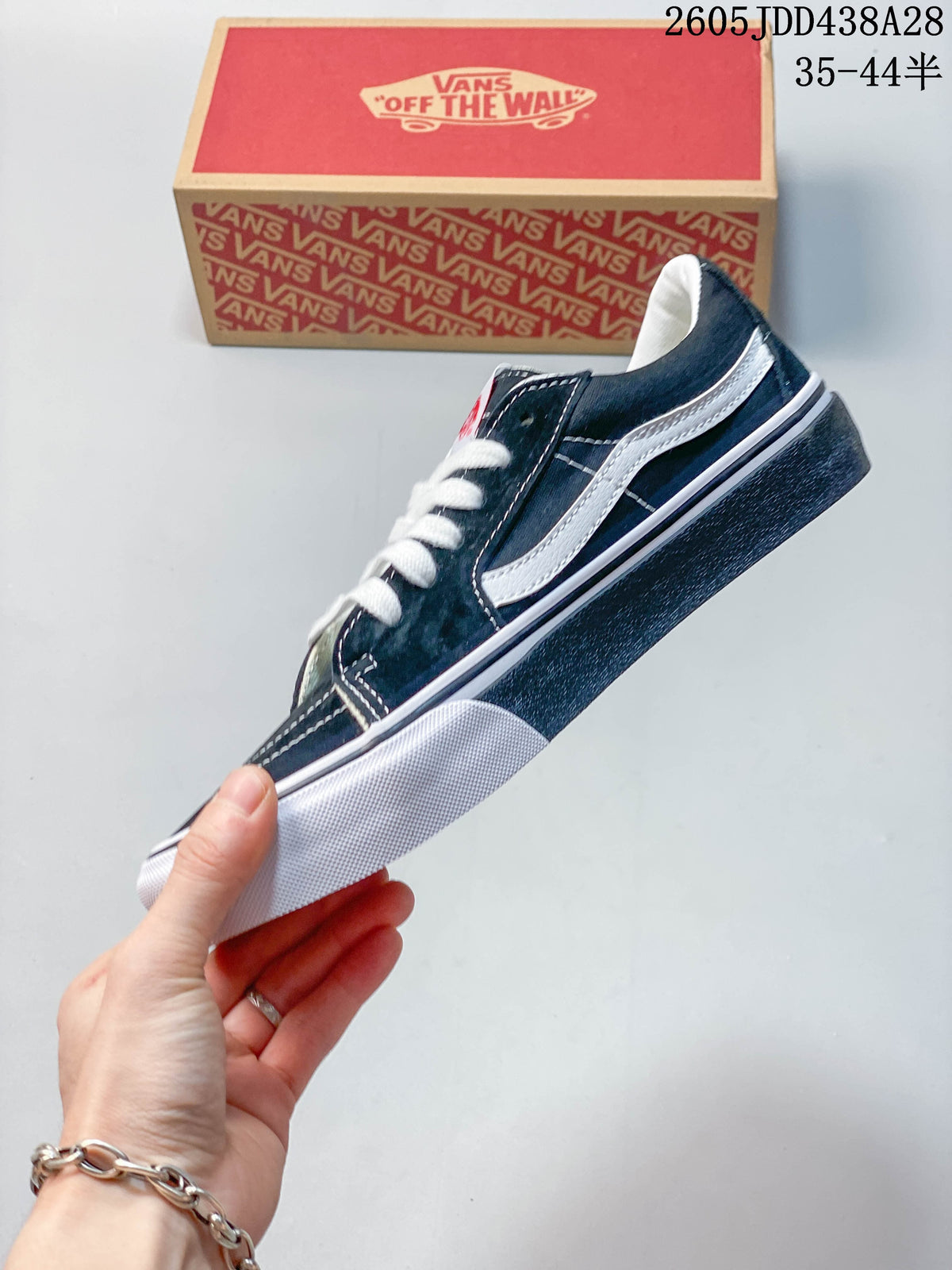 Side view of a dark green Vans Old Skool sneaker with a white stripe and sole.