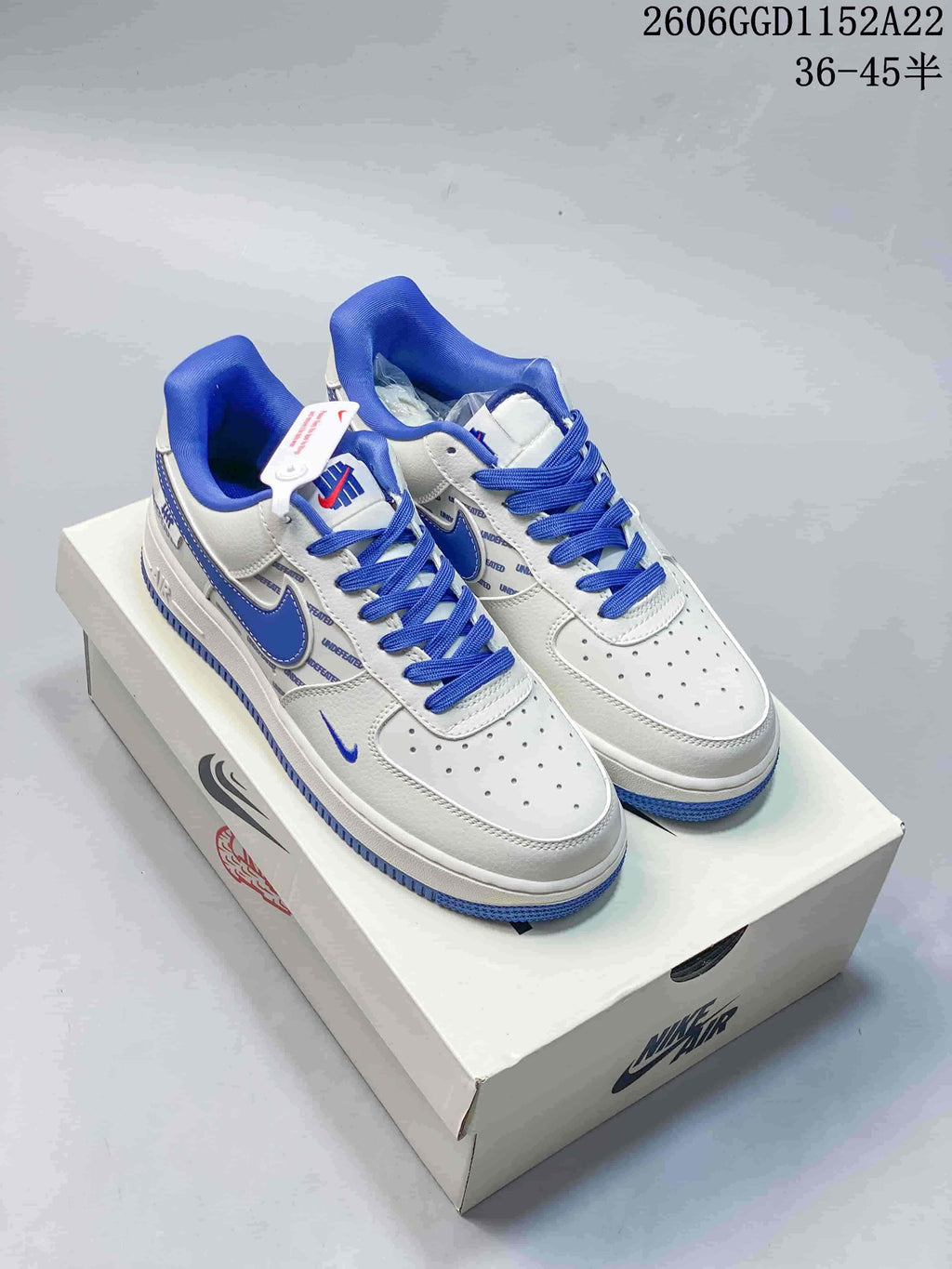 White and blue low-top Air Force 1 sneakers shown from the front and side