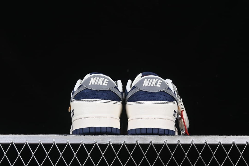 Rear view of the pair showing gray heel tabs and navy heel panels.