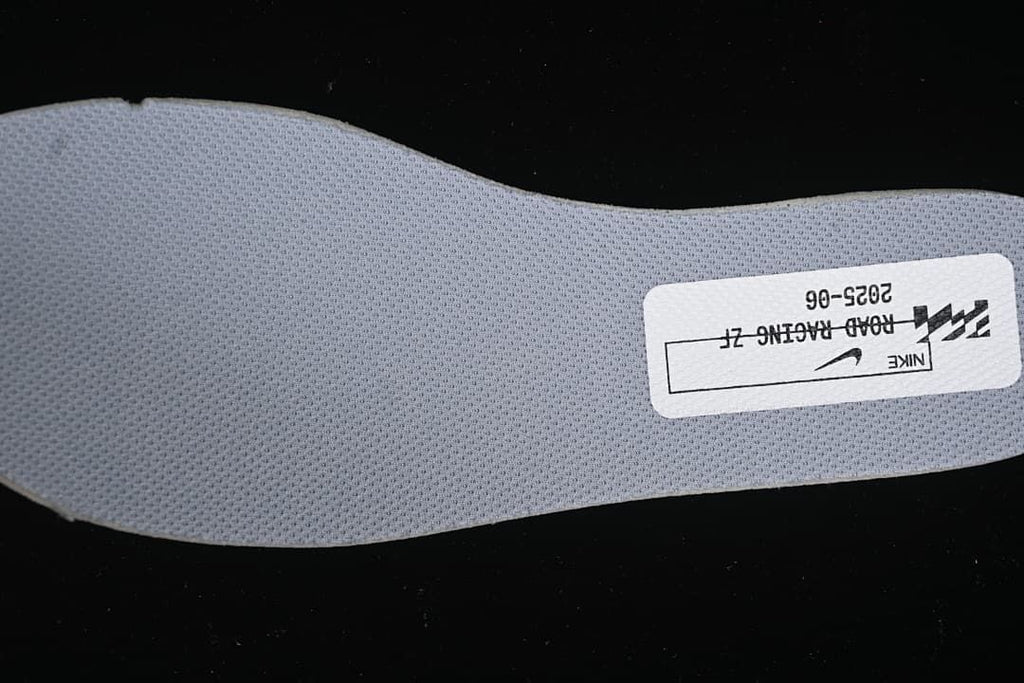 Close-up of a gray shoe insert with a printed Nike label.