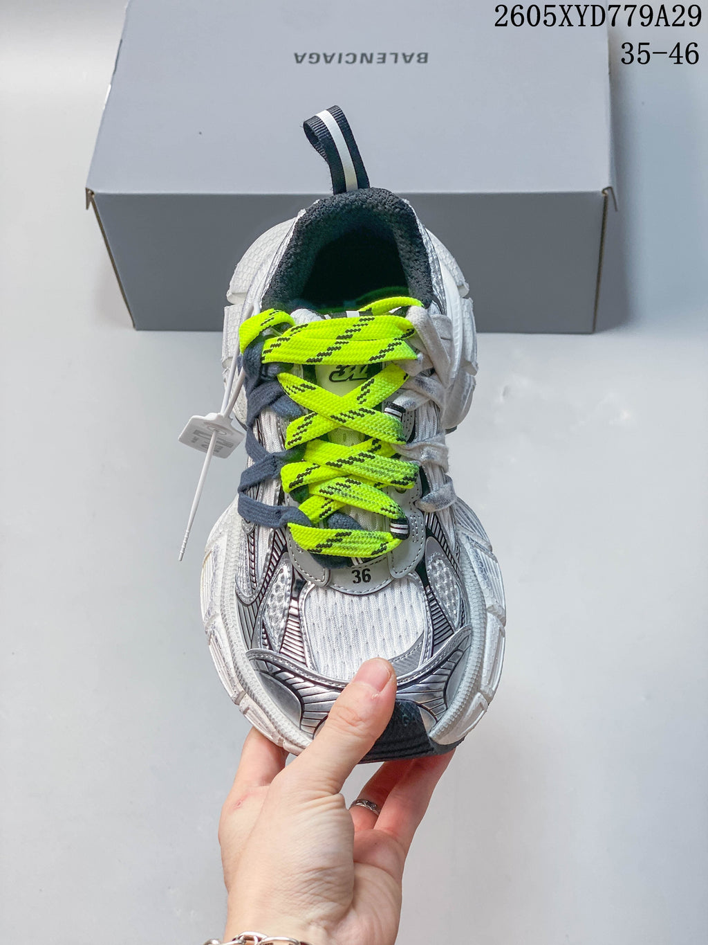 Front view highlighting the neon-yellow laces and silver-toned details