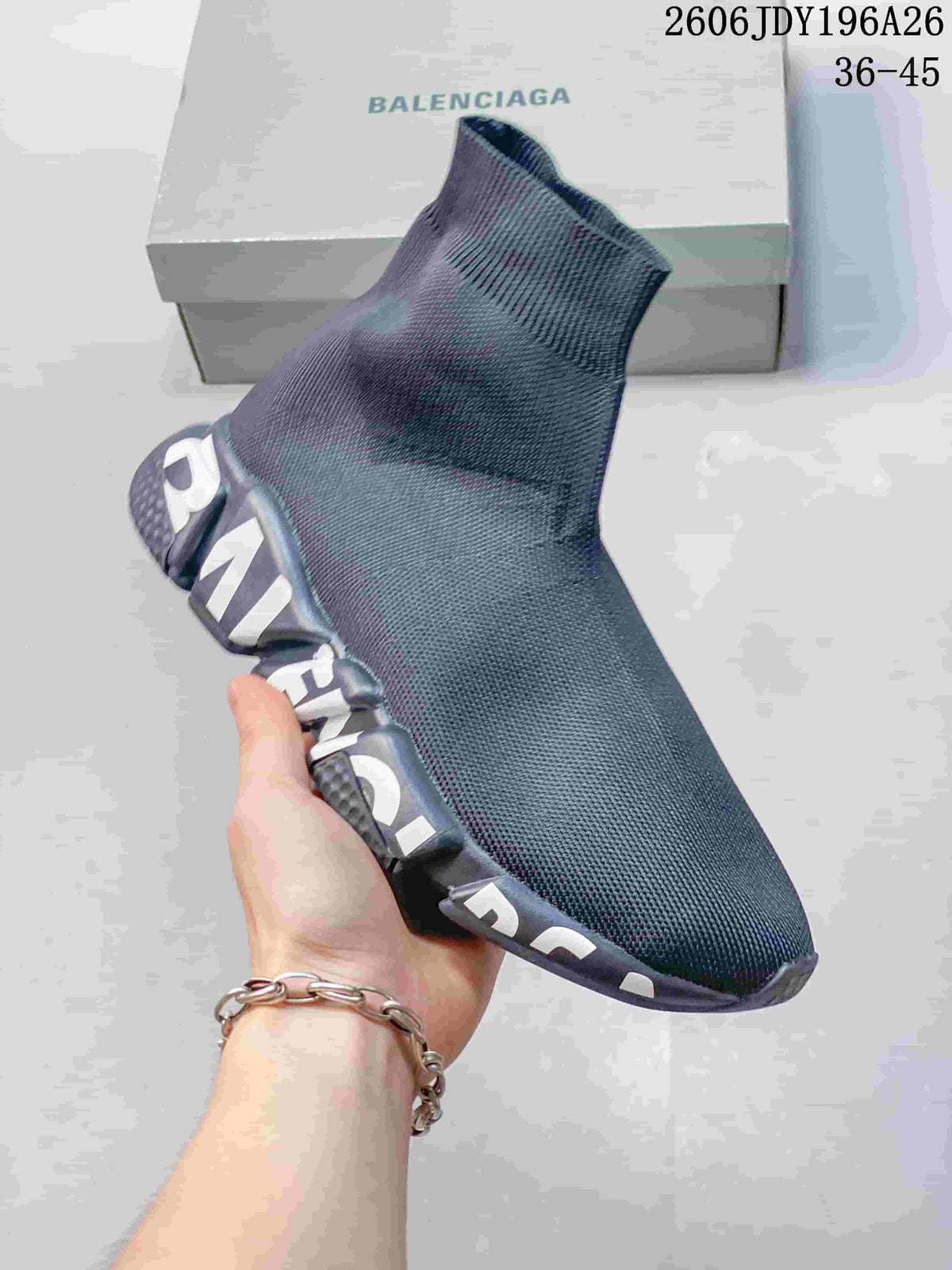 Close view of a plain dark gray sock-style sneaker with large lettering along the sole.