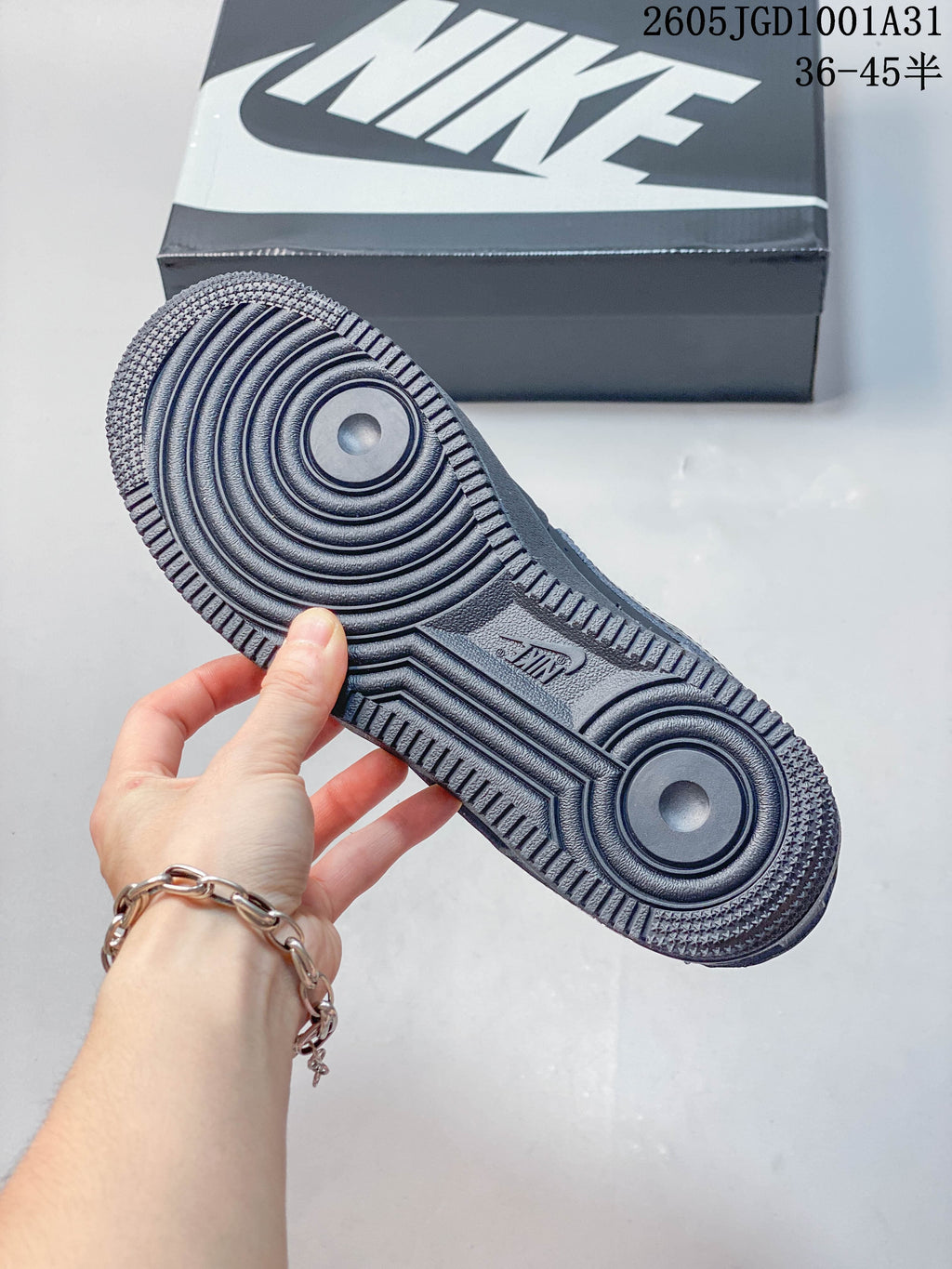 Underside of a dark navy sneaker showing circular outsole tread