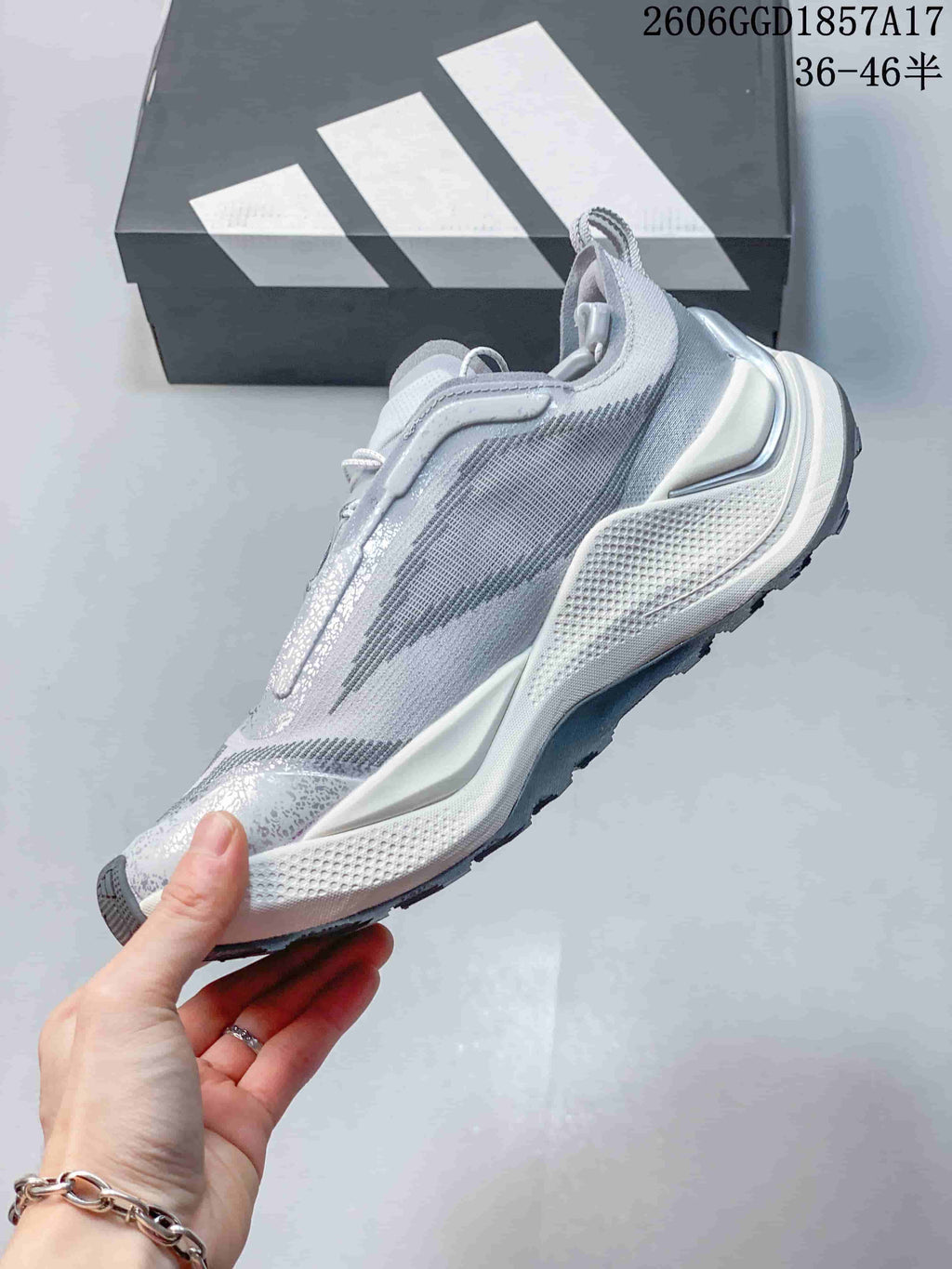 Side view of a light gray adidas Holo Peak trail-running shoe