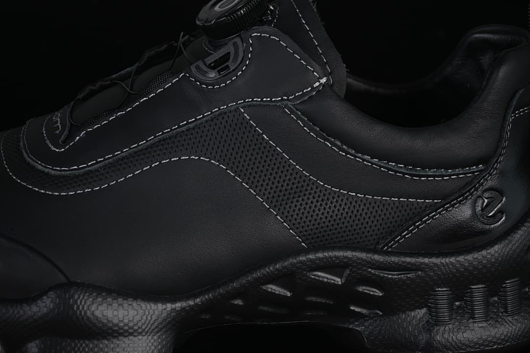 Close-up of the sneaker's perforated side panel and contrast stitching