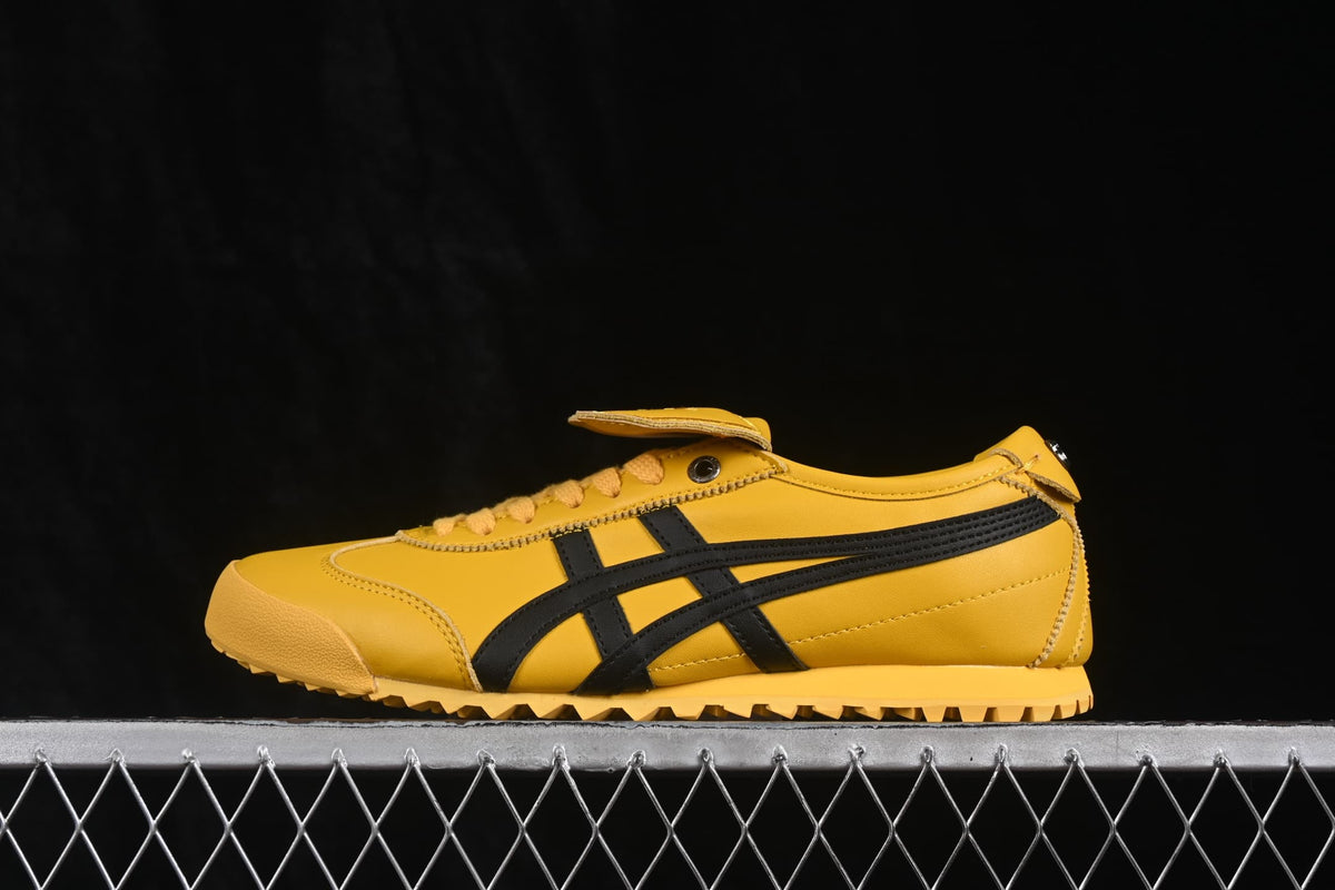 Opposite side view of the yellow sneaker with black branding stripes and toothed outsole