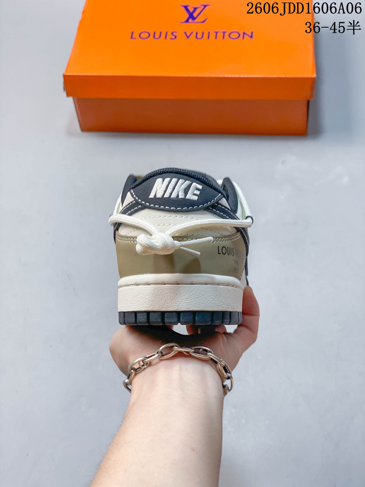 Rear view of a Nike SB Dunk Low sneaker with a cream heel and navy heel tab