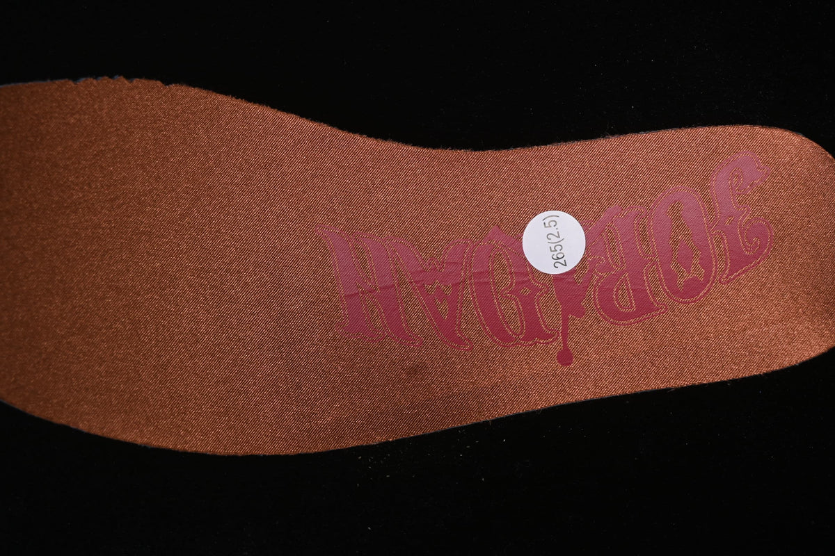 Close-up of a brown insole with a circular 265 (2.5) label